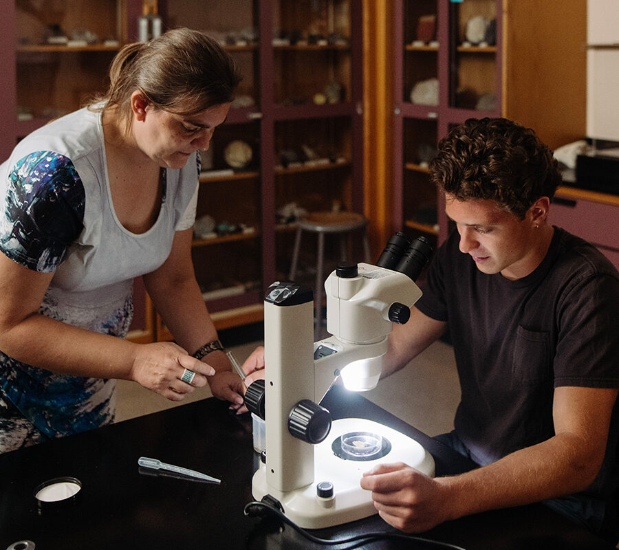 a biology student using a microscope in a laboratory