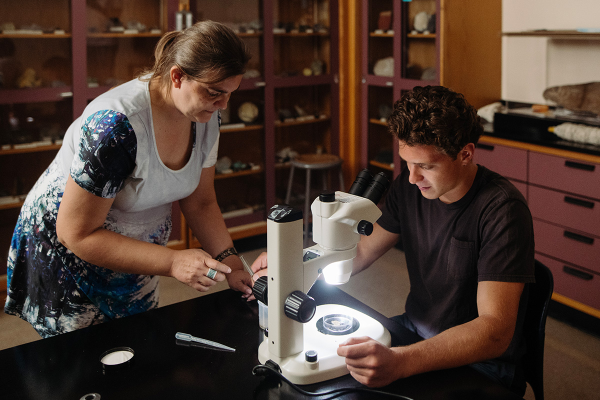 a biology student using a microscope in a laboratory