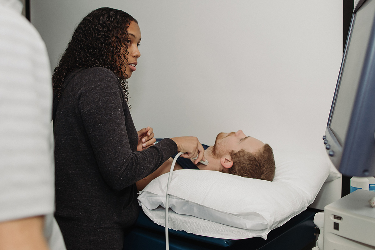 a health student performing a test on a patient