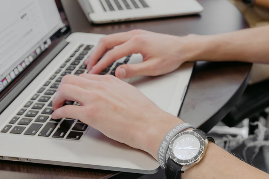 computer science student types on a keyboard.