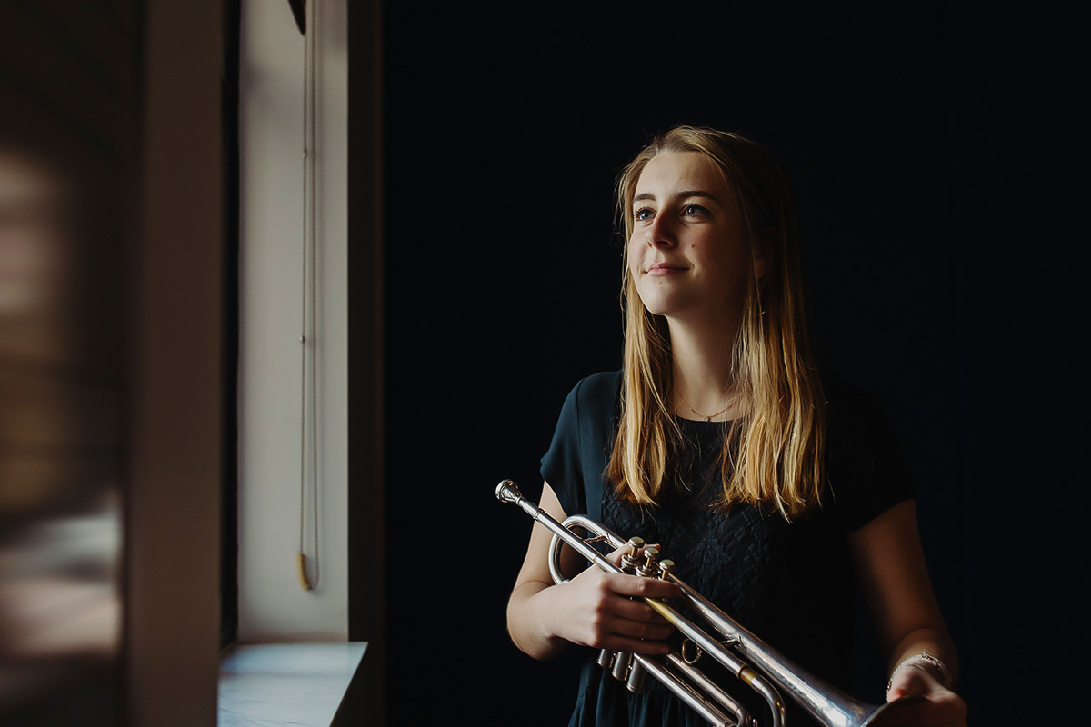 a student in the popular music degree holds a trumpet