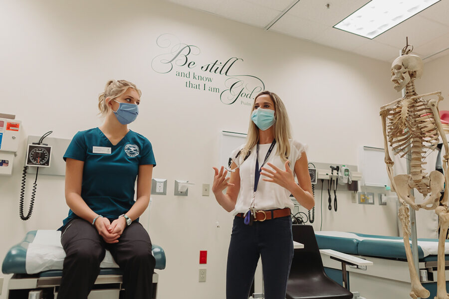 a faculty member teaching a health class in a nursing classroom