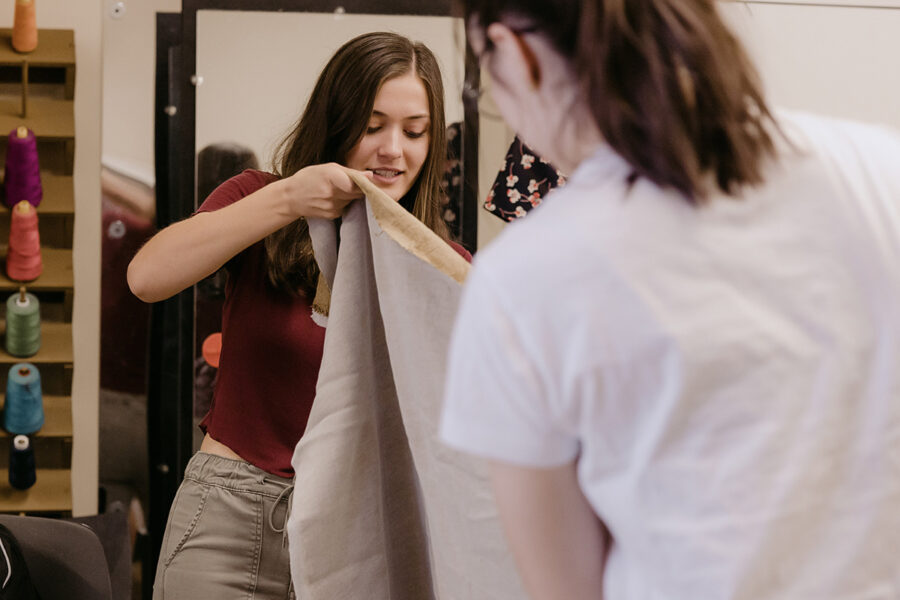 students from the degree in theatre arts making a costume with fabric