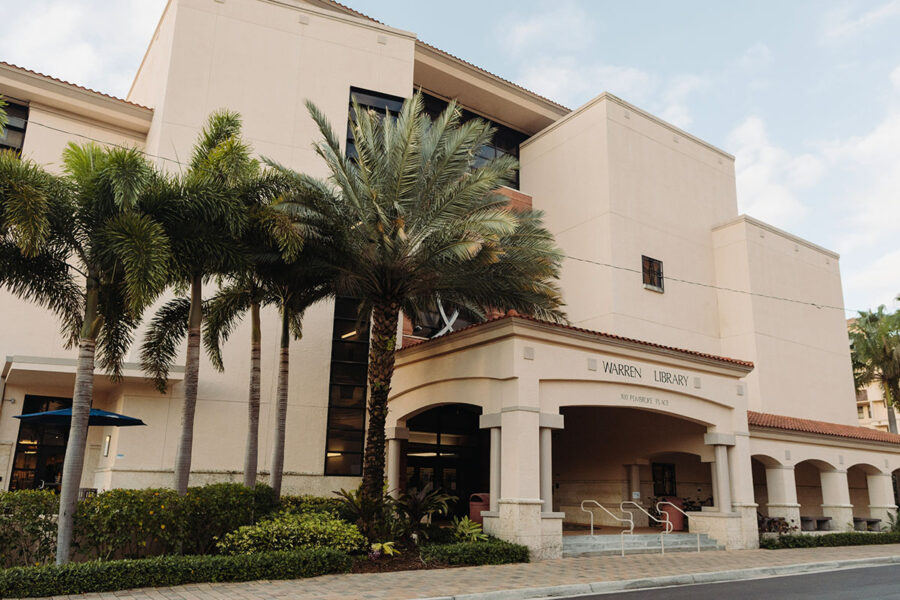 The Warren Library, framed by palm trees, on Palm Beach Atlantic University's campus.