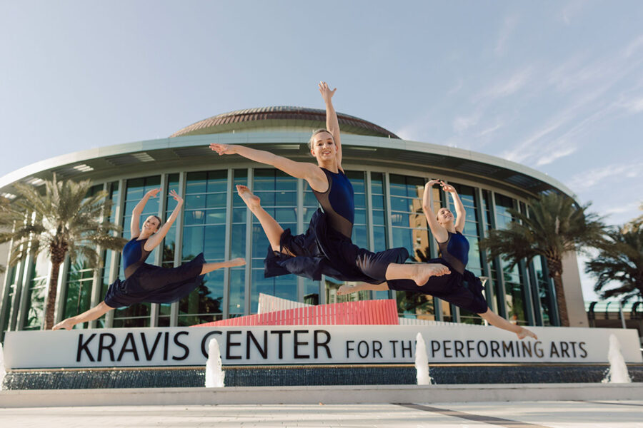 Three dance students perform outside the Kravis Center.