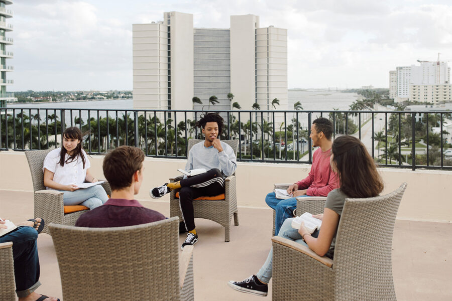 PBA students sit in a circle and talk.