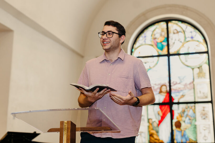 a student from the ministry leadership studies concentration in pastoral ministries program reads from the bible