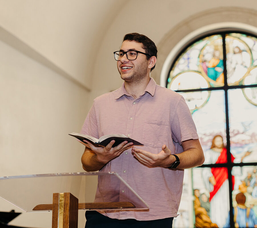 a student from the ministry leadership studies concentration in pastoral ministries program reads from the bible