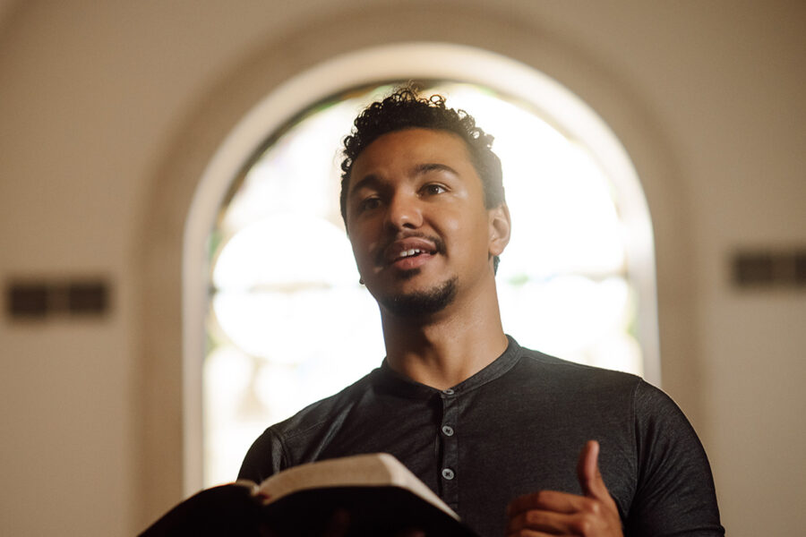 a PBA student holding a Bible while standing in the chapel