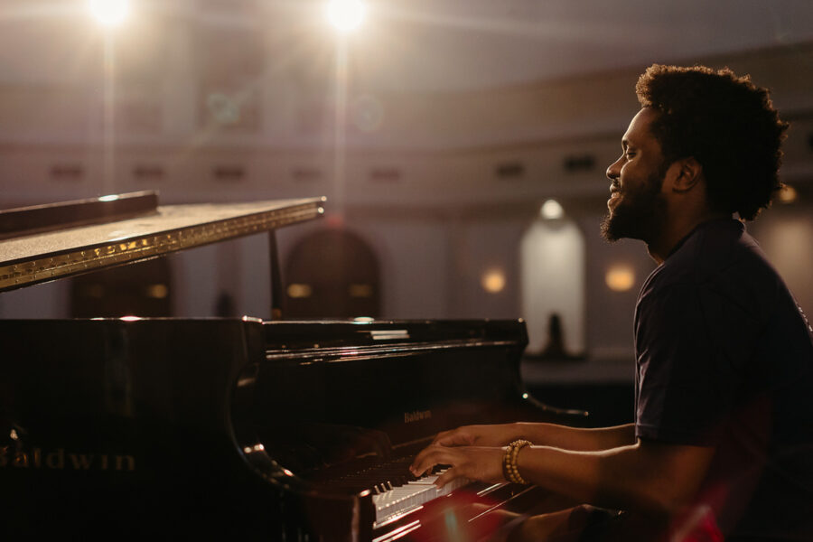 a keyboard performance major playing piano in a chapel