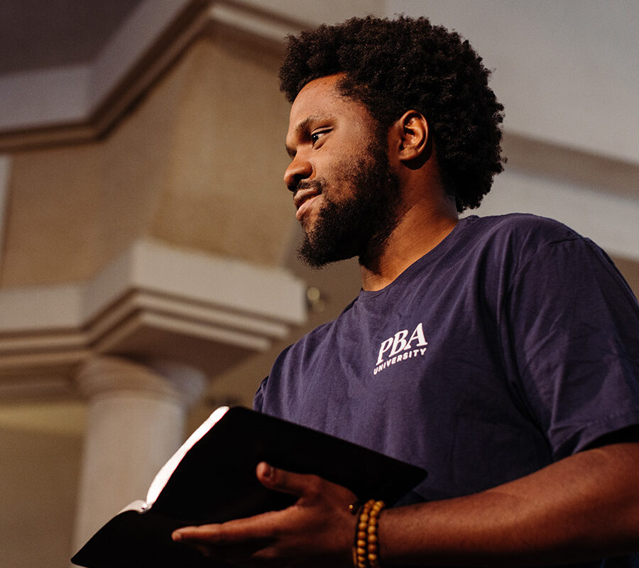 PBA student holds a bible in chapel.
