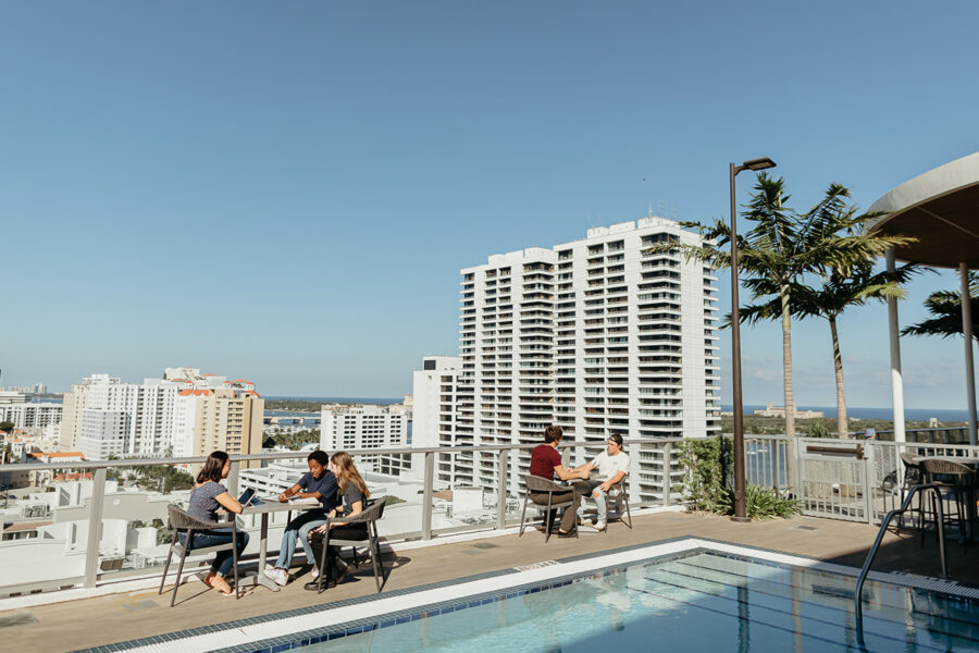 community development students sitting at tables on the rooftop of a building