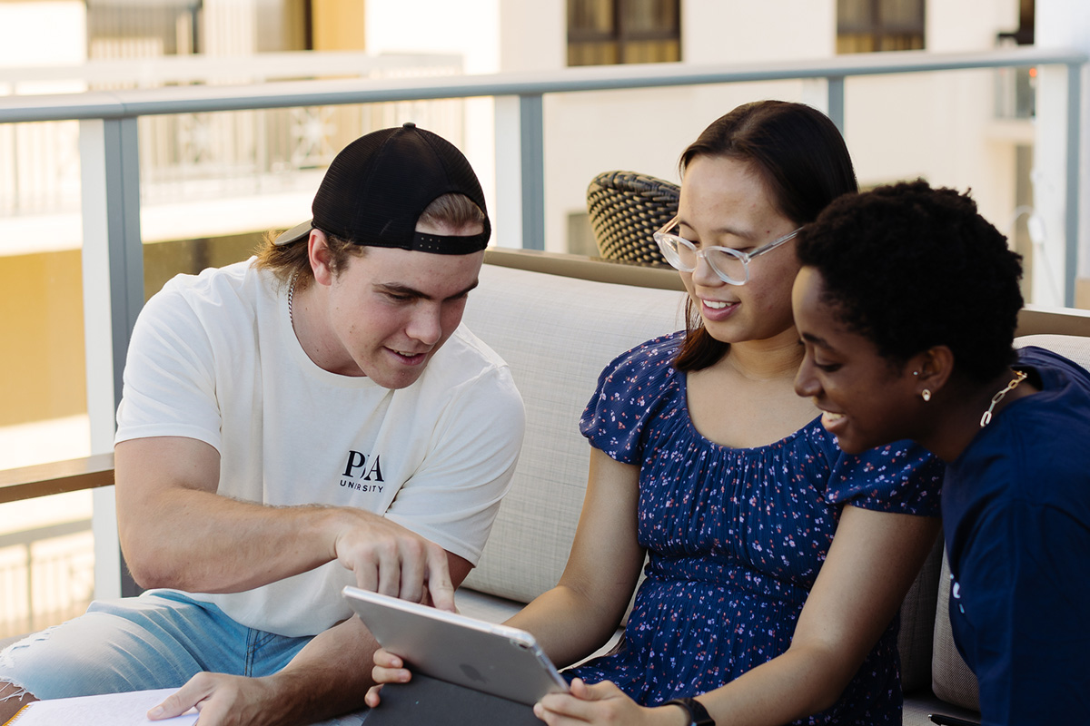 Students from the bachelor of general studies program study together on a balcony.