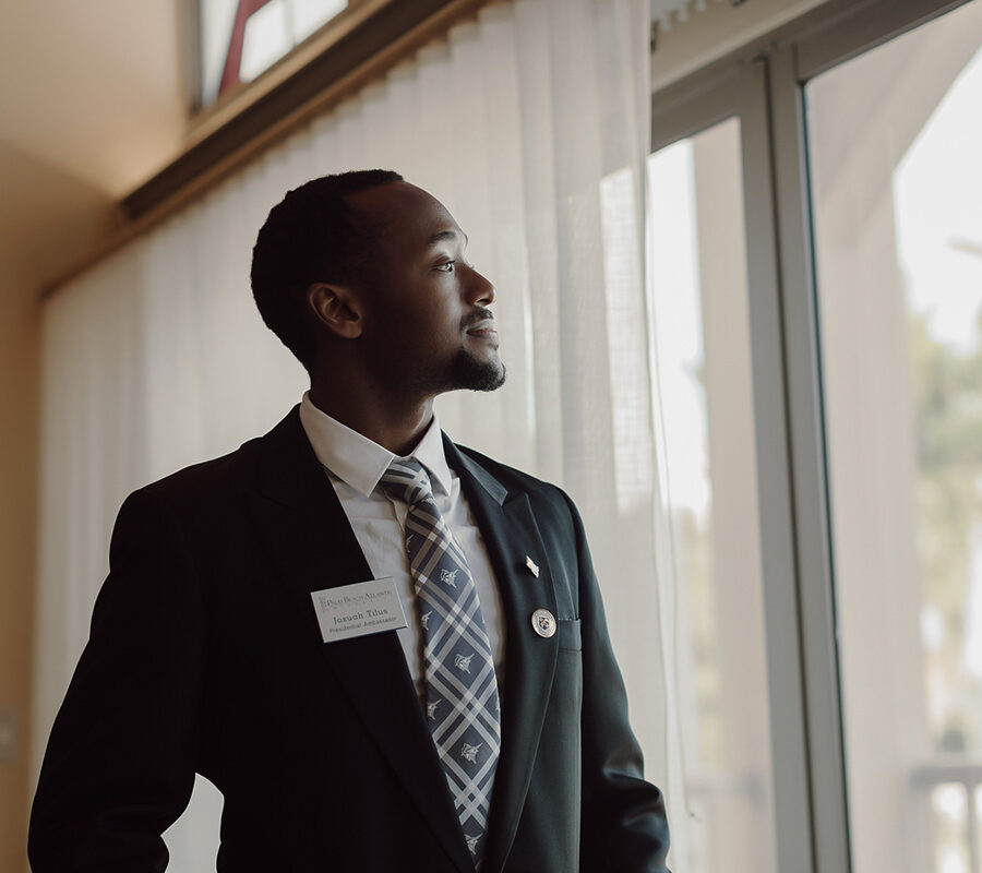 Business student looks out of window at Palm Beach Atlantic University