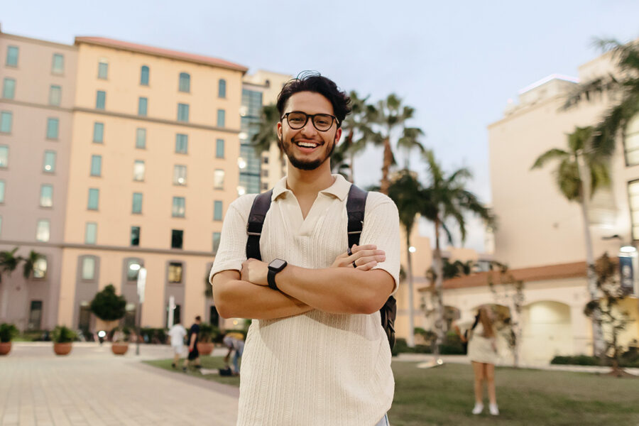 biblical studies minor student stands with arms folded on the PBA campus.