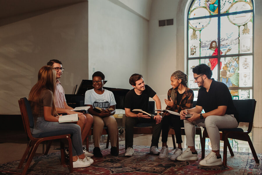 Christian Studies and Community Development students read together in a chapel.