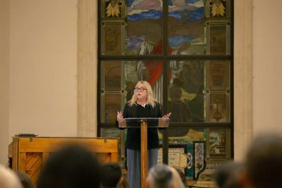 A person speaking on stage at the Apologetics Conference