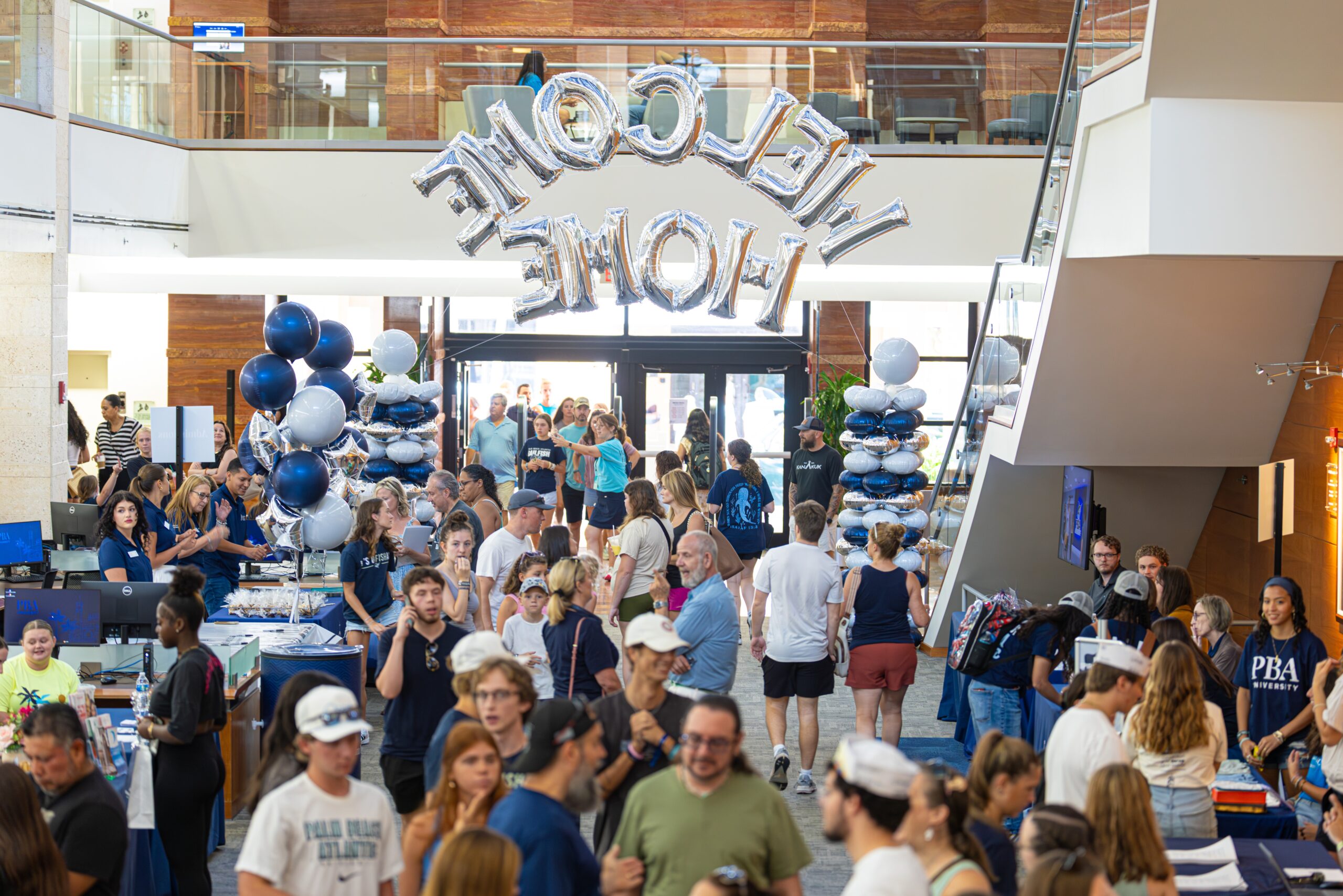 Welcoming balloons hang over Palm Beach Atlantic University's Warren Library and a crowd of newly enrolled students.
