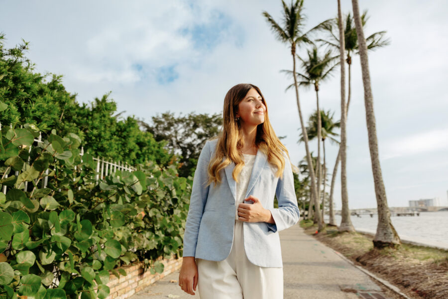 A Palm Beach Atlantic student enjoys the sun and Florida flora.