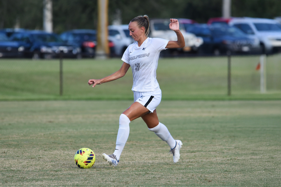 A student-athlete from Palm Beach Atlantic University kicks a soccer ball.