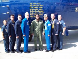 Roderick Farmer poses with his colleagues in front of a United States Air Force aircraft.