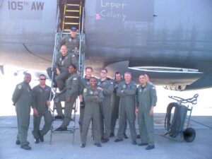 Roderick Farmer with his colleagues around the ladder of an aircraft.