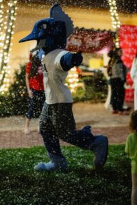 Palm Beach Atlantic University mascot Sailfish Jack frolics in fake snow.
