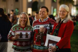 Palm Beach Atlantic University President Dr. Debra A. Schwinn poses with guests in festive attire.