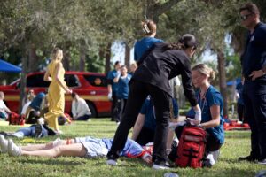 Nursing students and local emergency responders practice providing care in a disaster training simulation at Palm Beach Atlantic University.