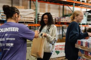 MLK Day of Service Tree of Life volunteers sort food into bags.
