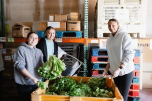 MLK Day of Service volunteers sort fresh produce at Tree of Life Resource Center.