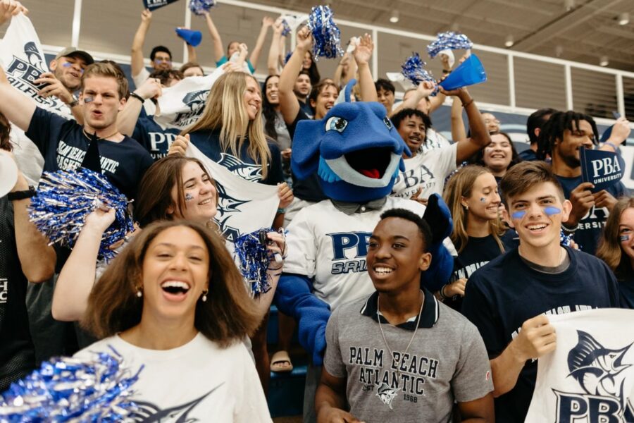 Palm Beach Atlantic University students and mascot cheer on Sailfish athletes.