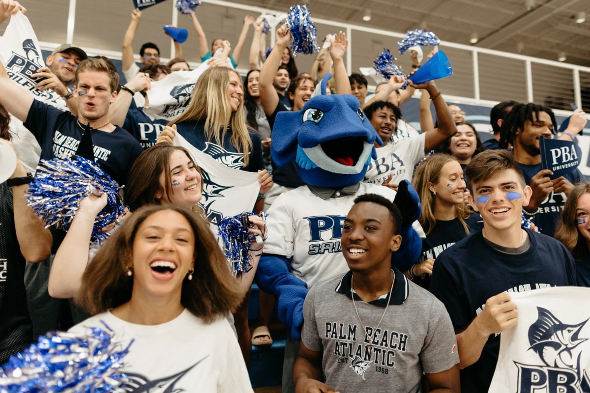 Palm Beach Atlantic University students and mascot cheer on Sailfish athletes.