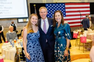 2026 Women of Distinction honoree Sarah McCann (right) with her husband and daughter.