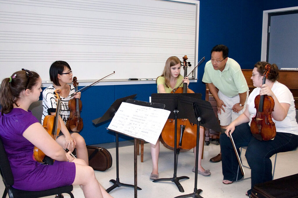 Teacher with string students in a classroom