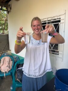 A Palm Beach Atlantic University student compares cups of filtered and unfiltered water.