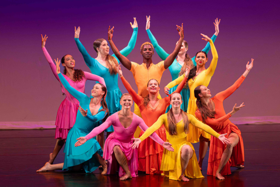 Dancers in a rainbow of costumes hold dramatic poses.