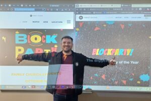 Pastor Jacob Kimbrell poses in front of a projector at PBA's first code-a-thon event.