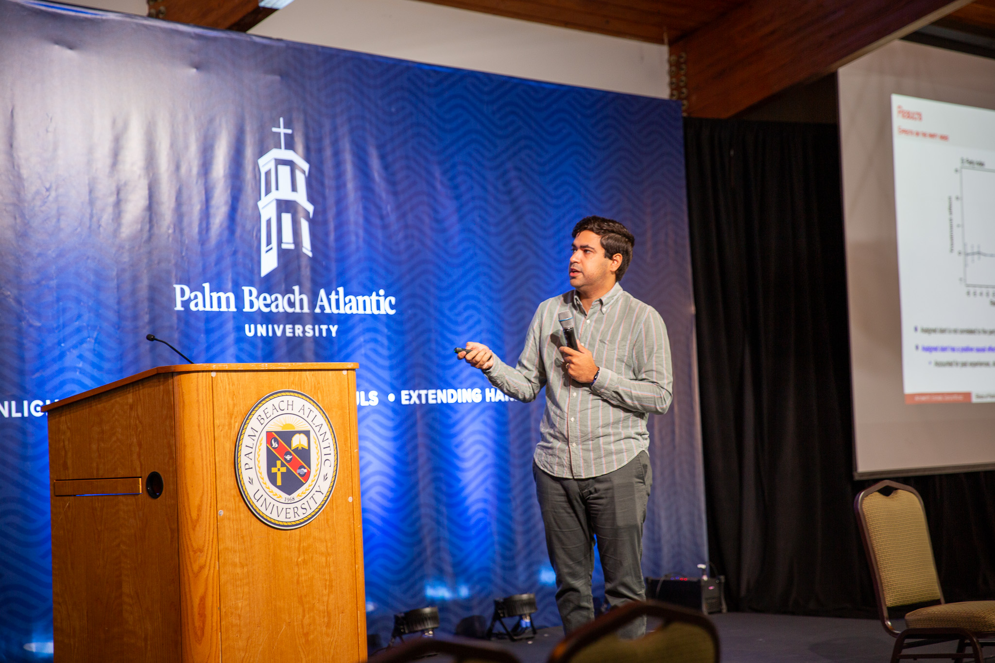 Man speaking in front of PBA logo
