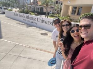 Family in front of Palm Beach Atlantic University sign
