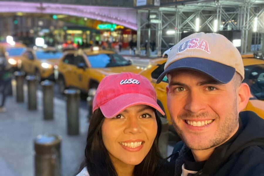 Joshua and Melissa Michael pose together on busy street