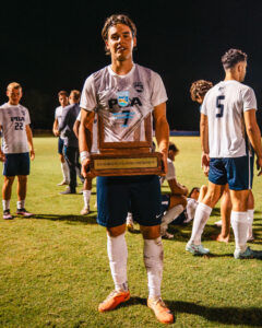 Tin Vastic holds Palm Beach Atlantic University soccer trophy.