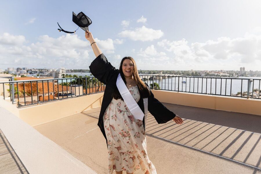 Geissy Yanel Quinteros Hofkamp toss her graduation cap on a rooftop in South Florida.