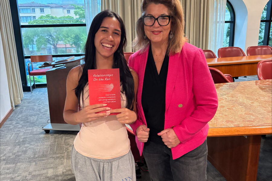 Palm Beach Atlantic University student Maryanna Batista poses with Dr. Stephanie Bennet and book.