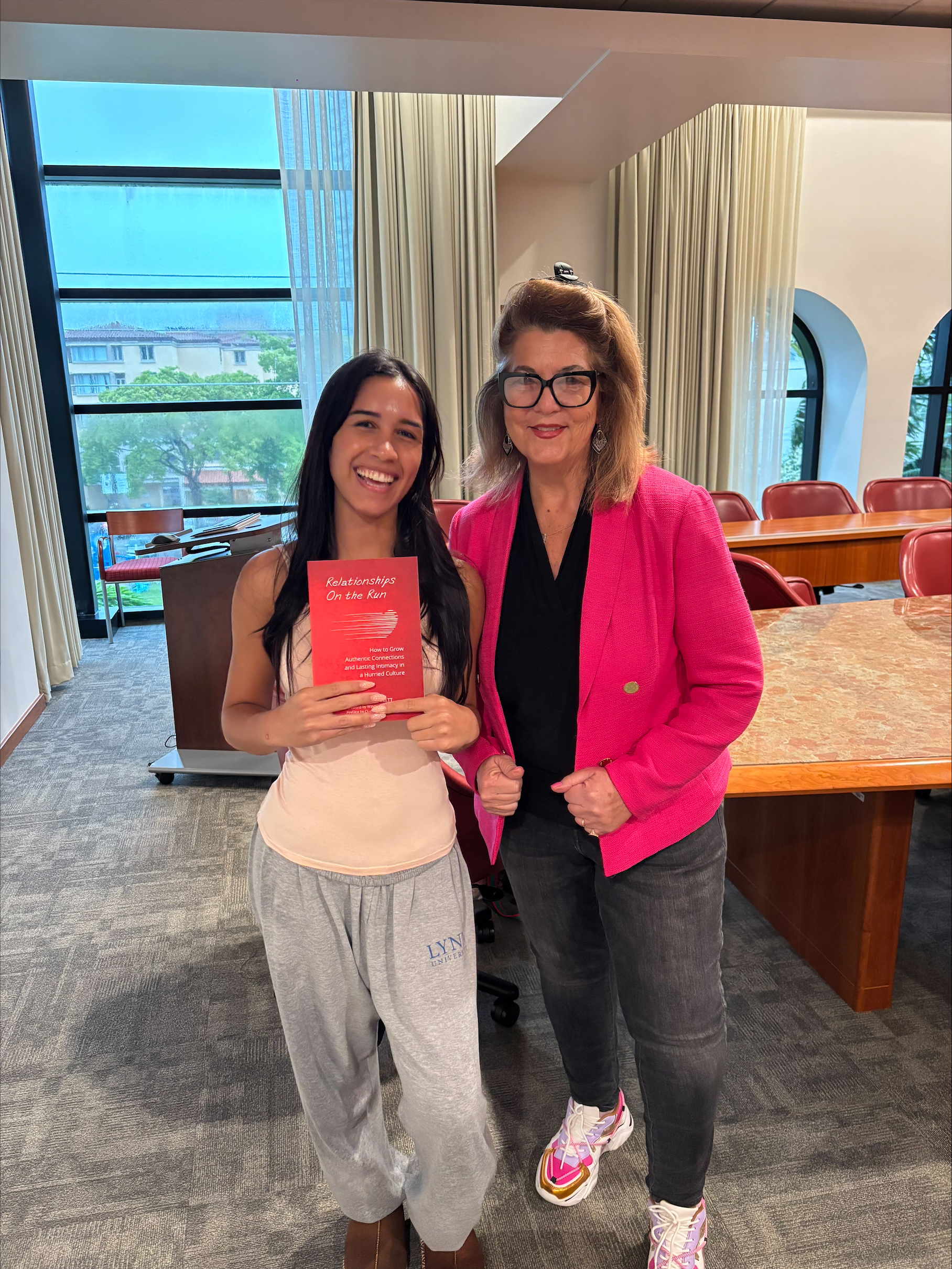 Palm Beach Atlantic University student Maryanna Batista poses with Dr. Stephanie Bennet and book.