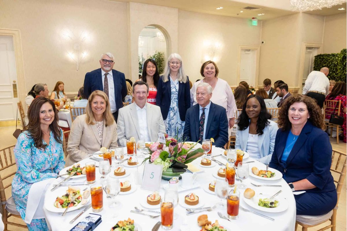 Palm Beach Atlantic University executives sit together at Palm Beach Chamber of Commerce Award Luncheon. Photo credit: @capehartphotography