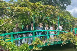 Palm Beach Atlantic University's Frederick M. Supper Honors Program students and professors stand on a bridge in France.