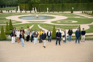 Palm Beach Atlantic University's Frederick M. Supper Honors Program students and professors walk through French gardens.