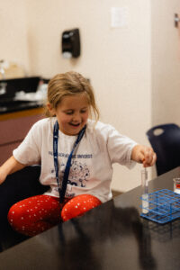 A student conducts an experiment with test tubes in the Palm Beach Atlantic University Summer Science Camp.