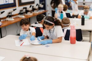 Summer Camp students practice a science experiment in a Palm Beach Atlantic University laboratory.